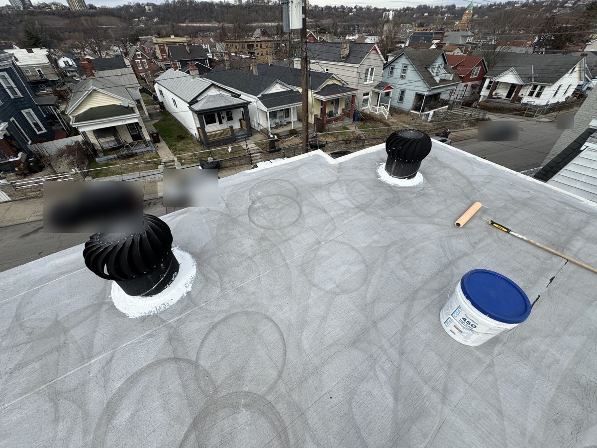 Freshly cleaned flat roof with turbine vents, ready for silicone coating