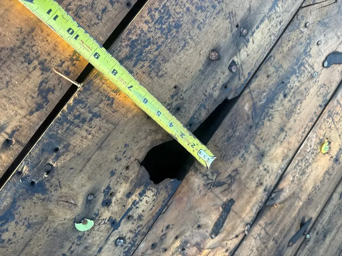 Tape measure showing gaps in spaced board roof decking, White Oak, Cincinnati