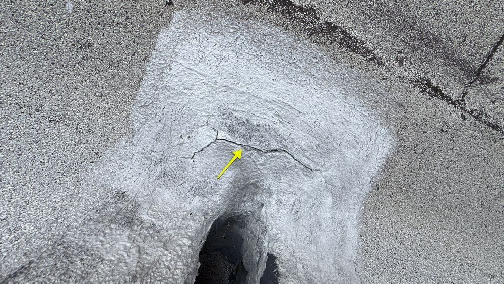 Cracked acrylic patch over an open flat roof seam