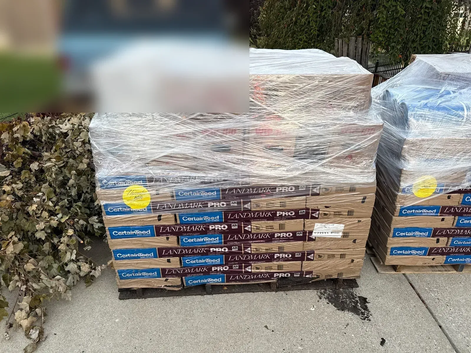 Pallets of CertainTeed Landmark PRO shingle bundles delivered to the driveway