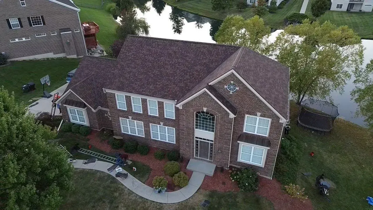 Drone view of a finished roof replacement on a two-story brick home in Florence, KY