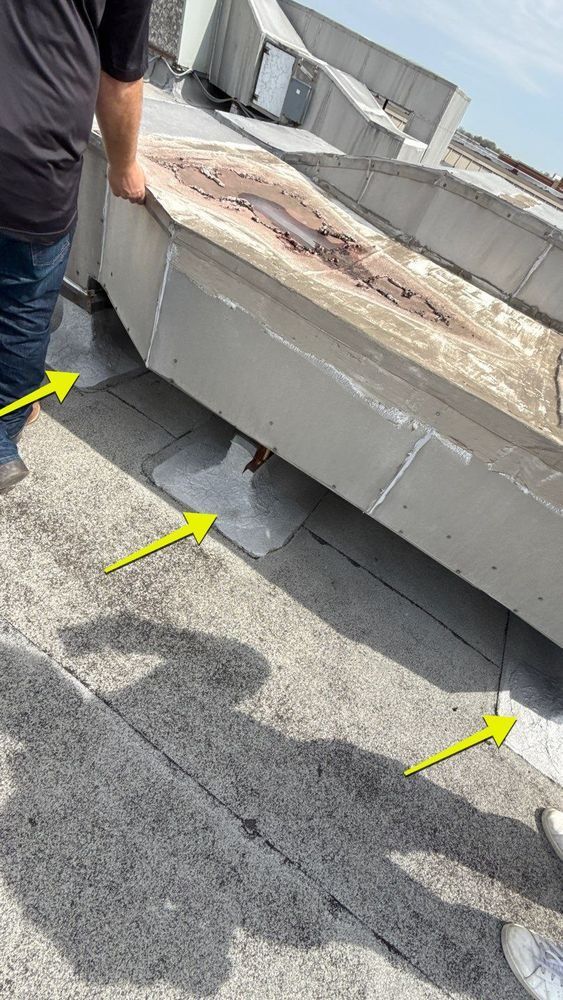 Failed liquid-applied flashing at the base of a rooftop HVAC curb