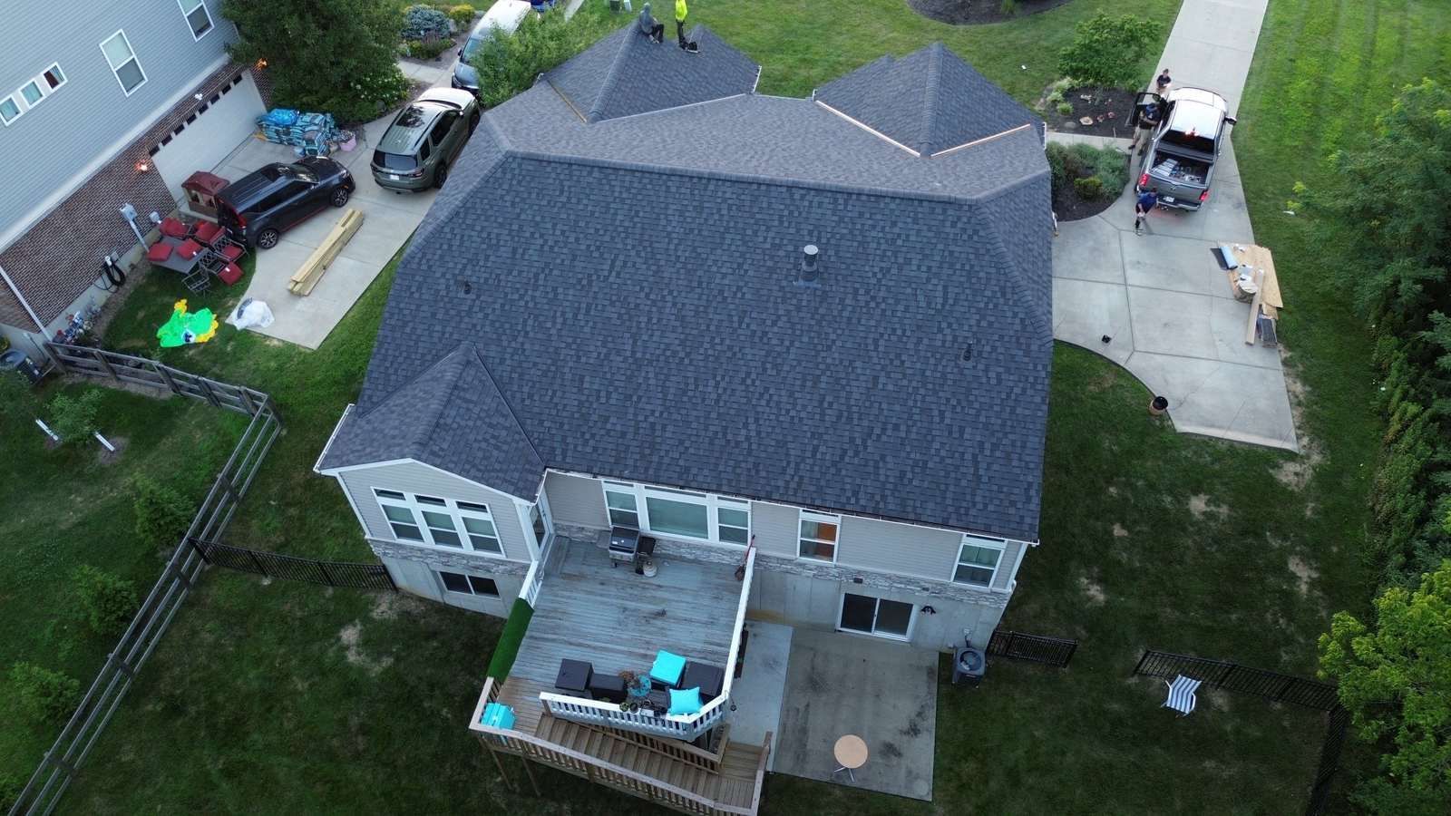Drone view of a finished roof replacement in Independence, KY with dark architectural shingles