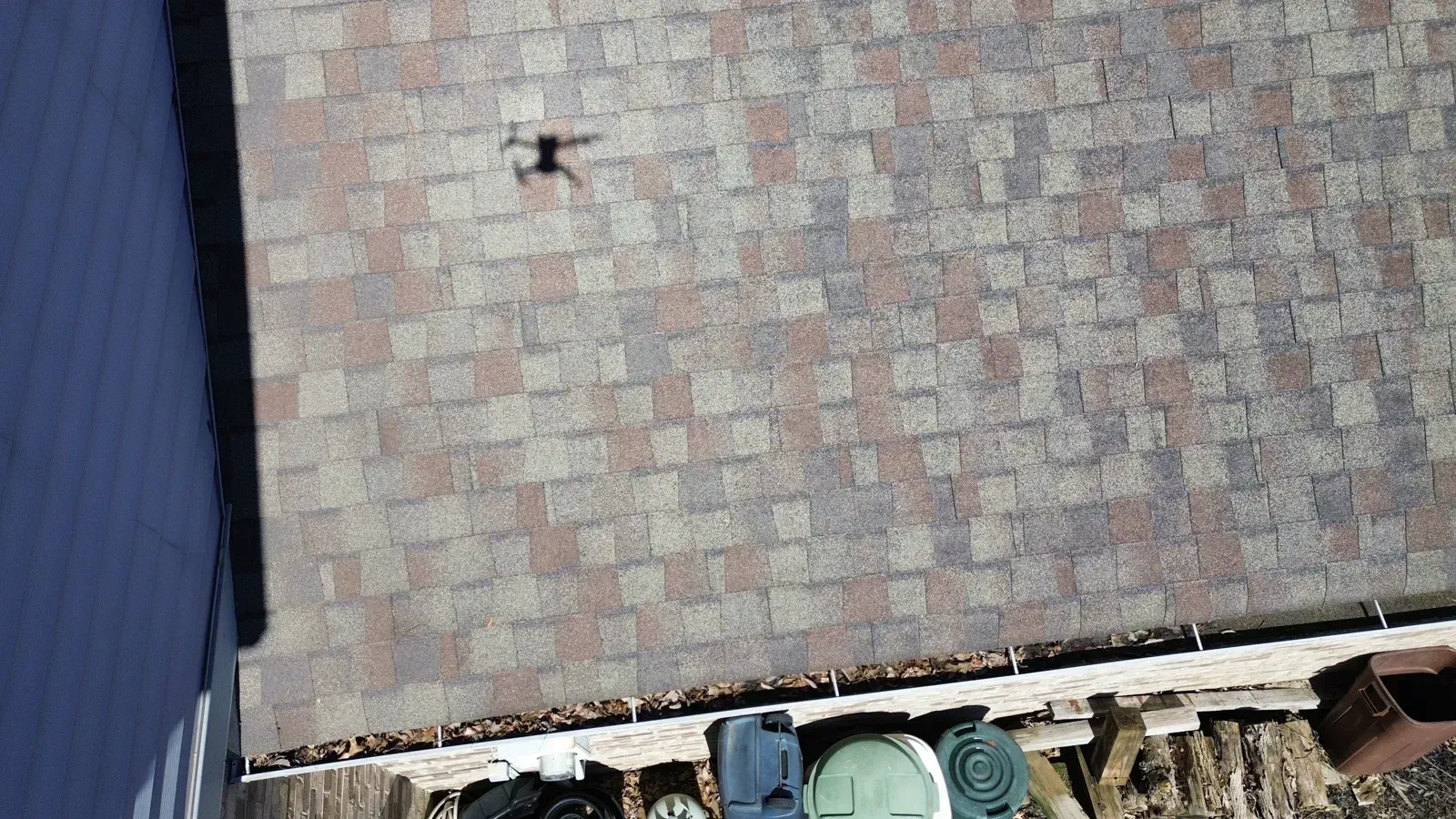 Wind-damaged shingles on a Florence, KY colonial seen from a drone