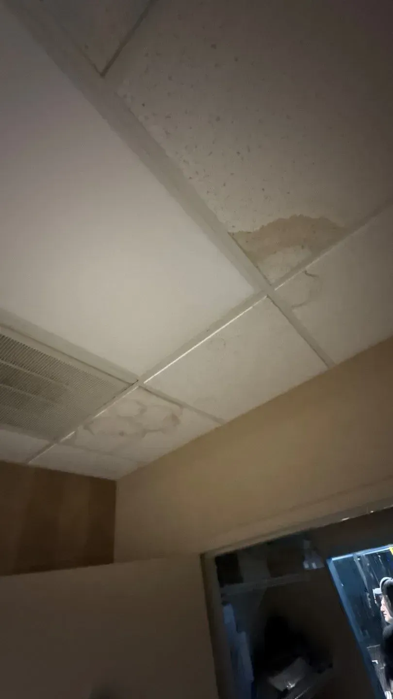 Water-stained ceiling tile inside a Florence, KY office building from roof leaks