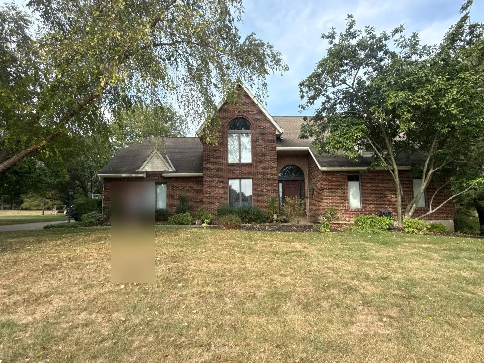 Florence, KY brick home off Tiburon Dr before its hail damage roof replacement