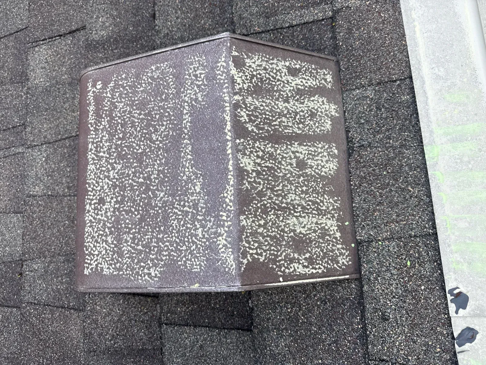 Chalk-marked hail hits on a metal roof vent, Florence, KY
