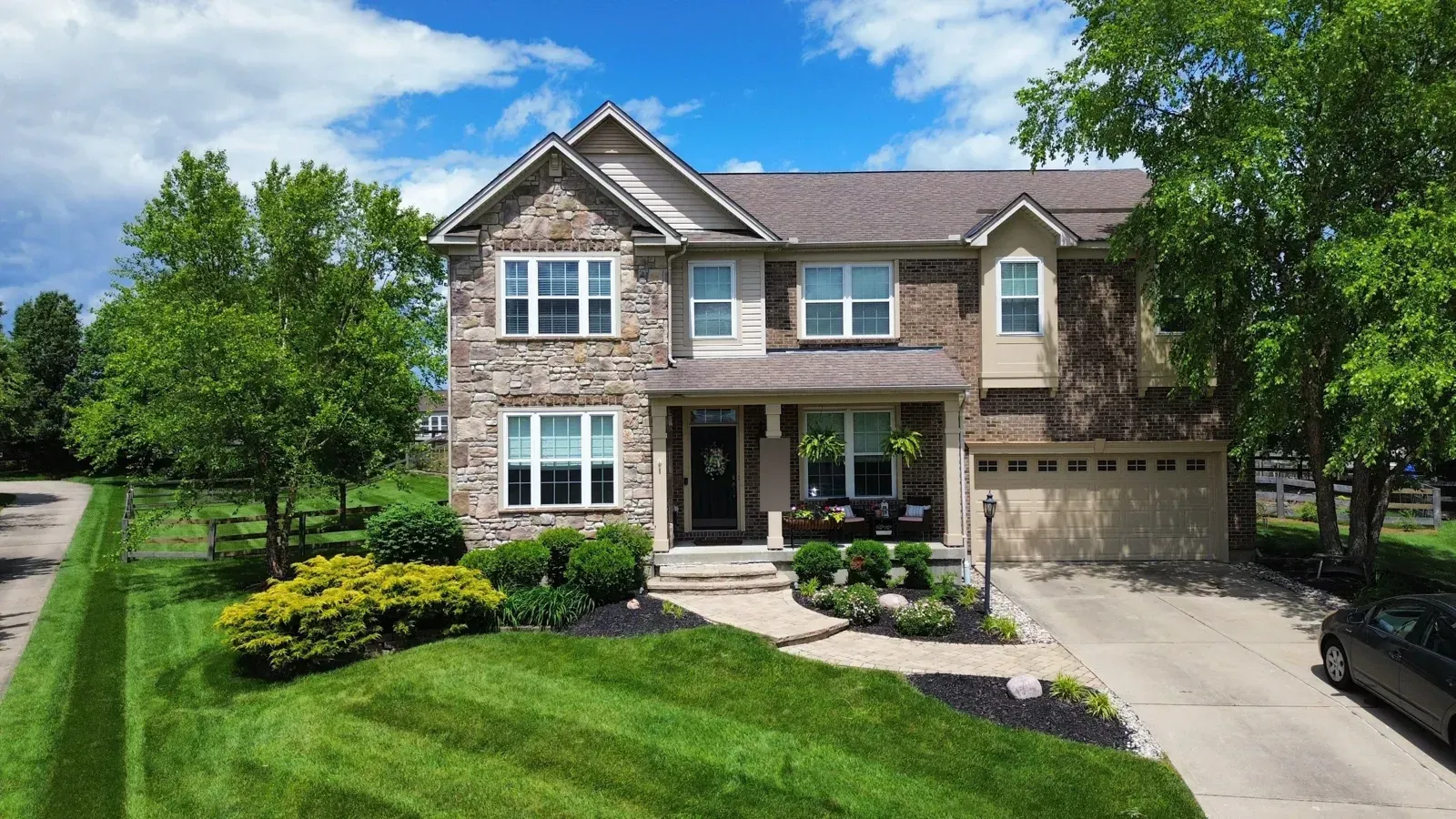Stone and brick two-story home in Florence, KY before its hail and wind roof replacement