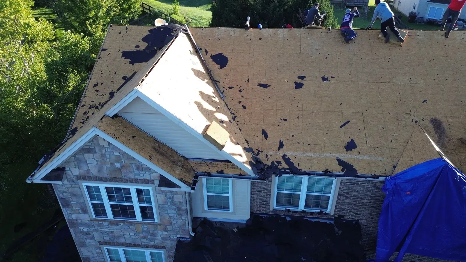 Drone view of the tear-off down to the roof deck on a Florence, KY stone and brick home