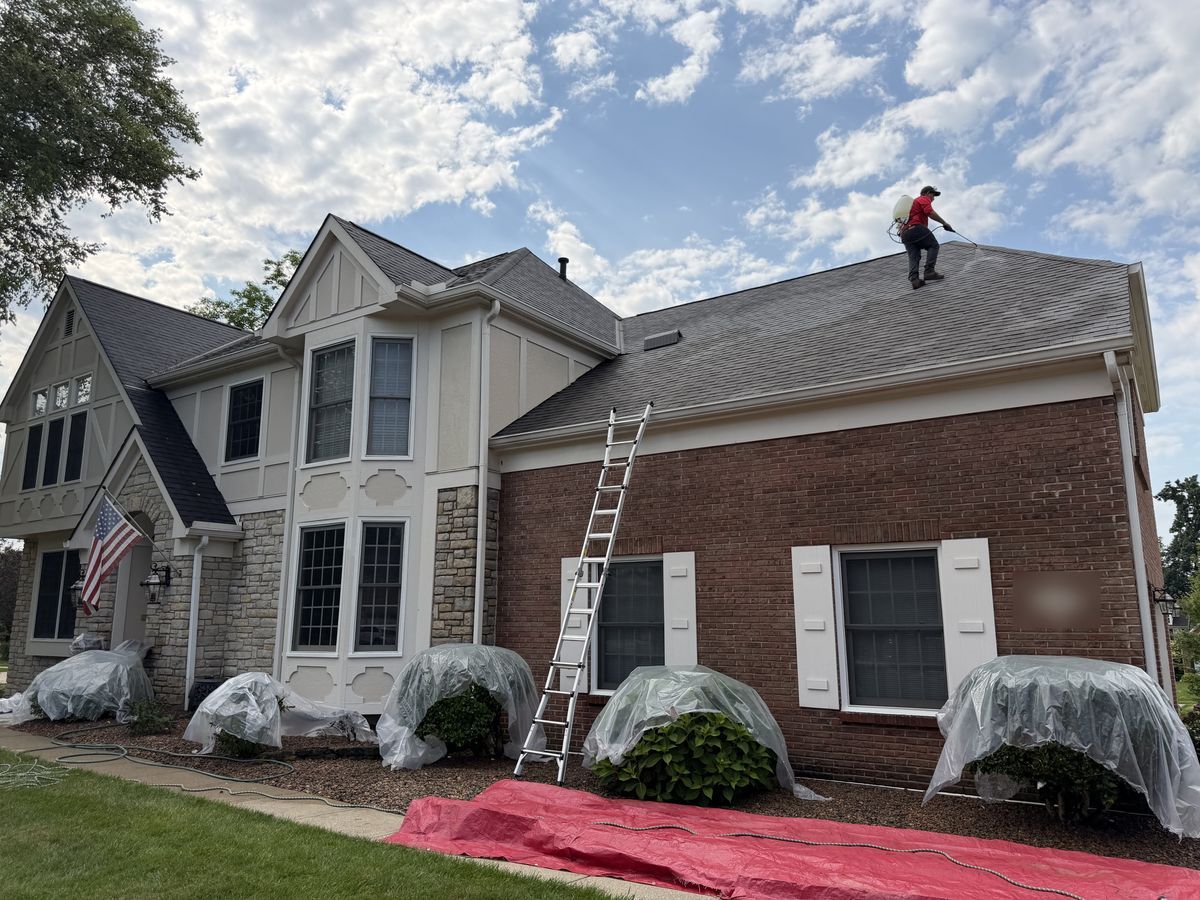 Fortress technician on roof with landscaping covered for protection