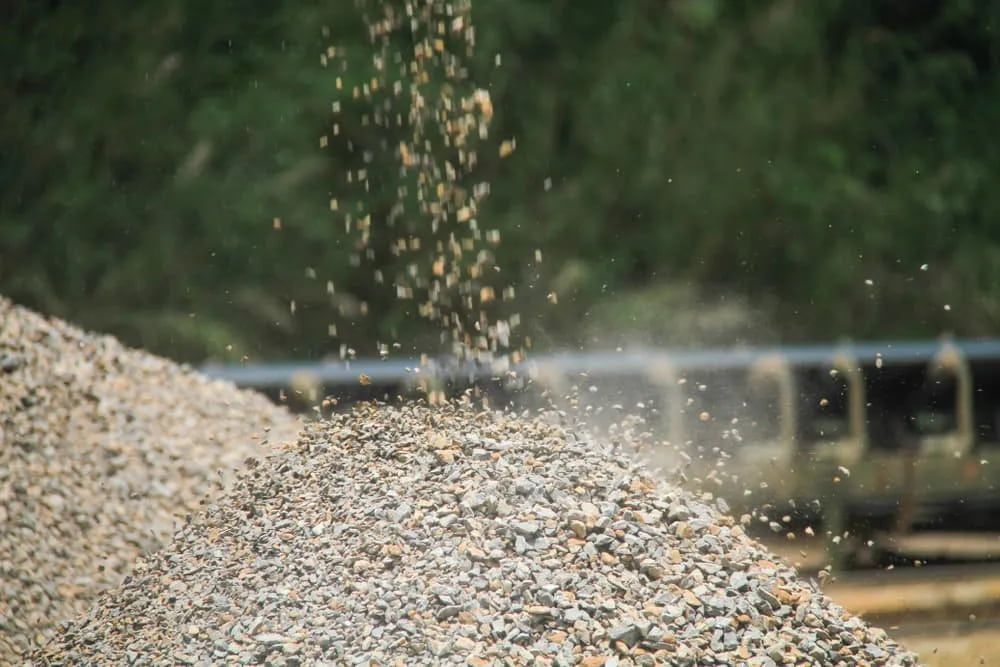 Gravel Being Poured Onto a Pile; a Vehicle and Trees in the Background — The Soil Yard in Delacombe, VIC