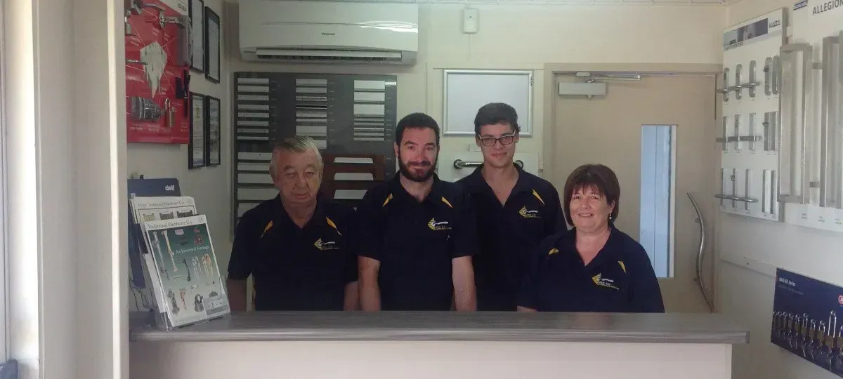 A Group of People Standing Behind the Counter | Bundaberg, QLD | Wide Bay Architectural Hardware
