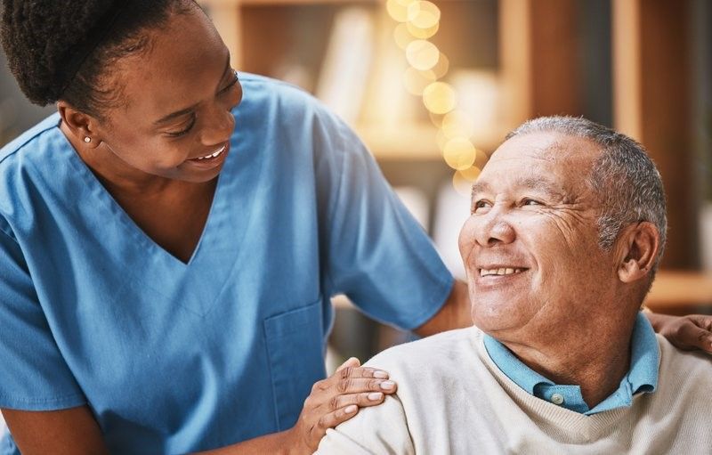 A nurse is talking to an elderly man in a wheelchair. A nurse is talking to an elderly man in a wheelchair.