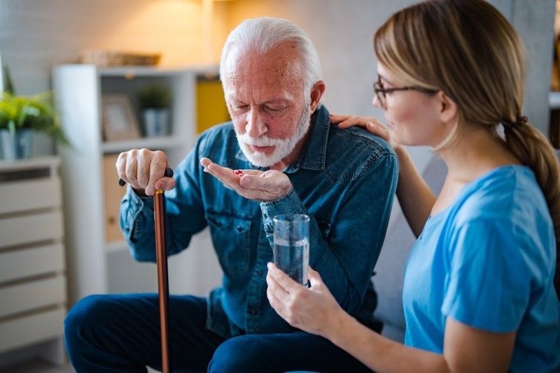 Woman receiving IV therapy while browsing on her phone.