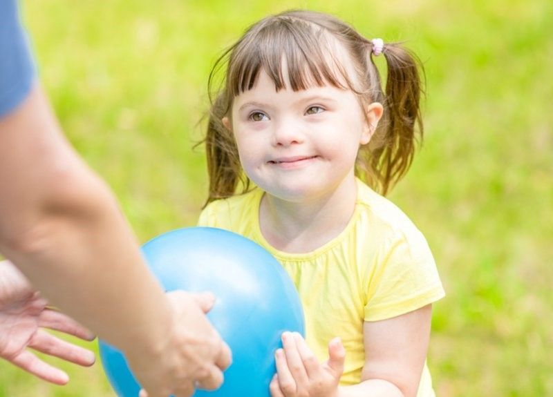 A little girl holding a ball. A little girl holding a ball.