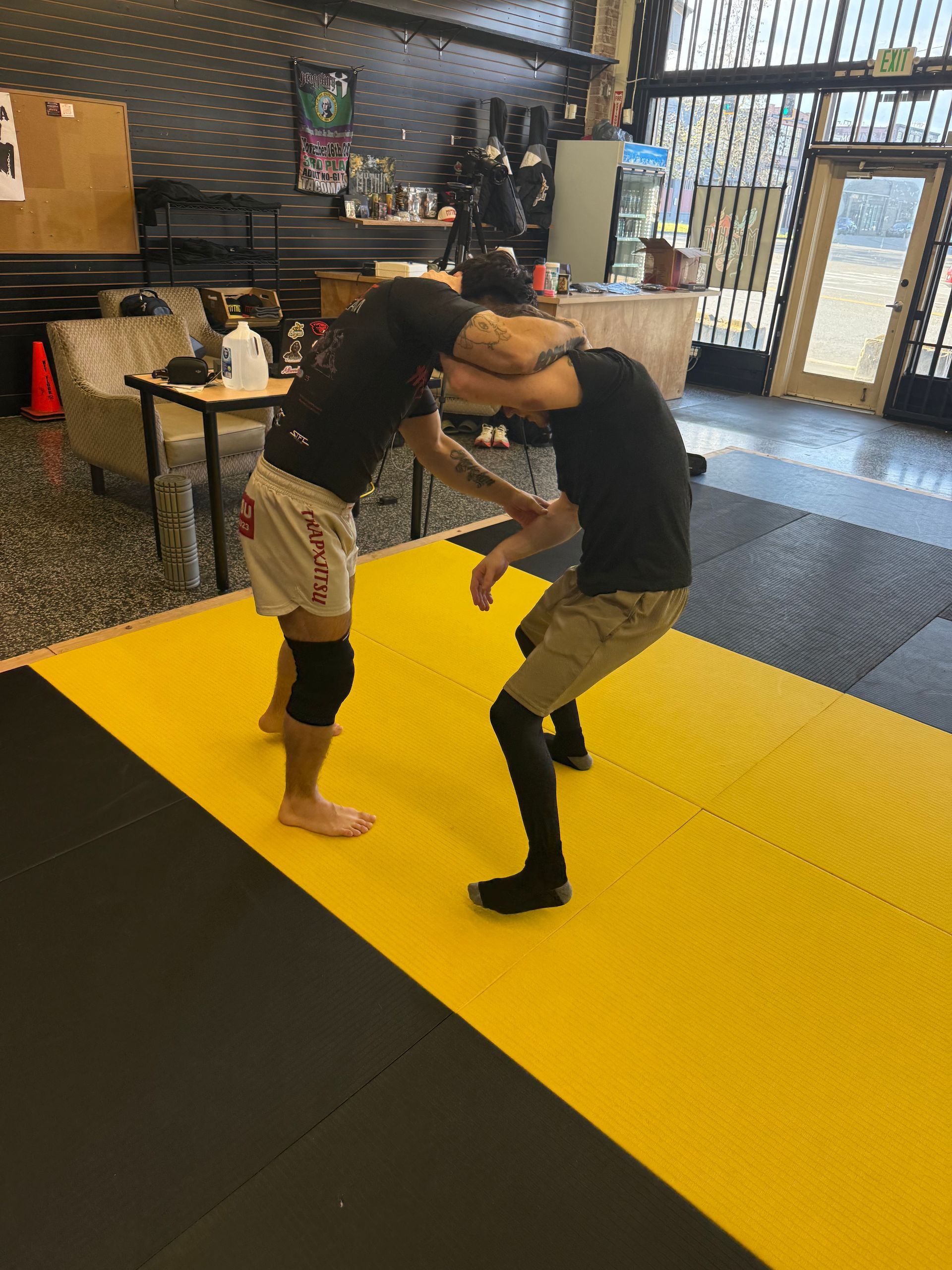 Adults drilling Jiu-Jitsu techniques at Mythic Martial Arts in Tacoma, WA for fitness, stress relief