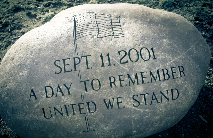 A large rock says sept 11 2001 a day to remember united we stand