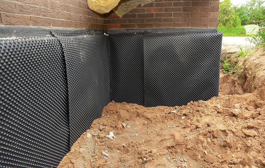 a pile of dirt next to a brick wall