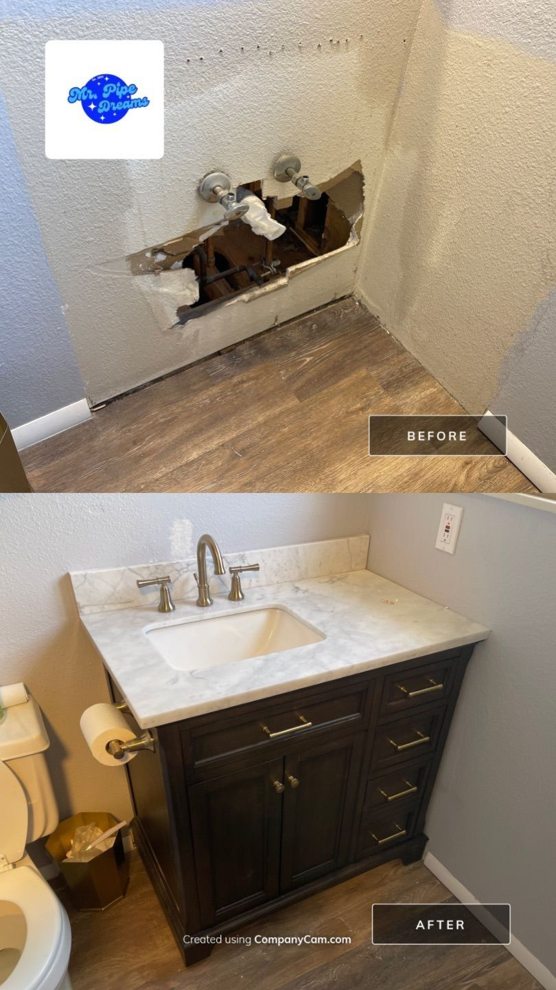 Staircase nook with wall damage above a bathroom vanity and sink below