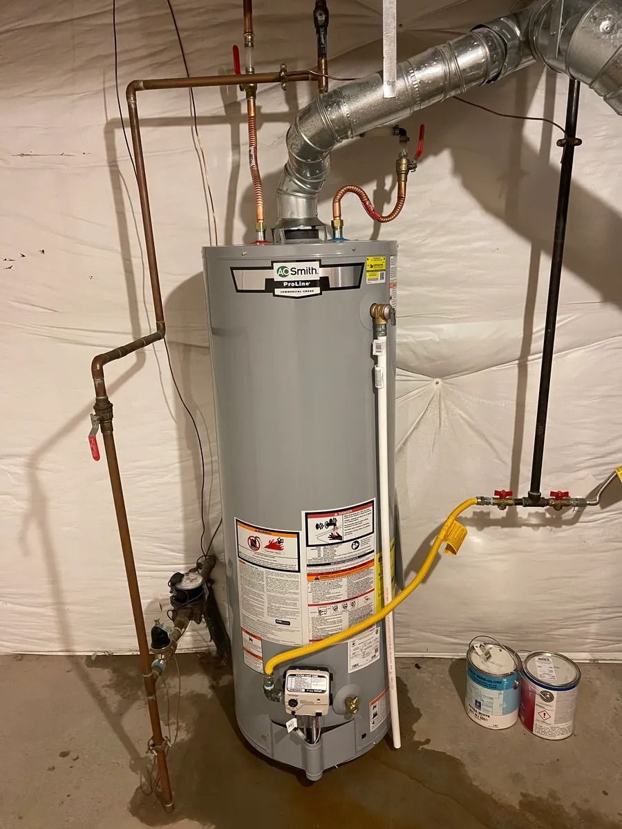 Water heater in unfinished basement with pipes, venting, and tools nearby