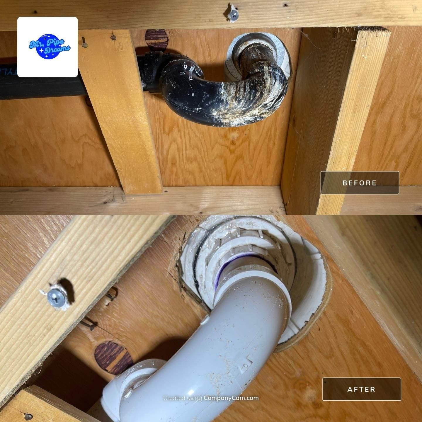 Split view of under-sink drain pipe before and after replacement, showing old black pipe and new white pipe.