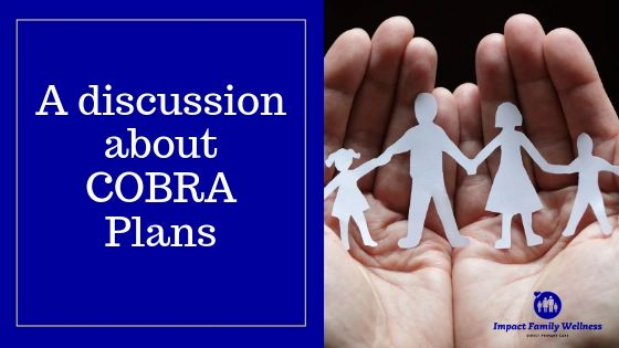 A person is holding a paper cut out of a family in their hands.