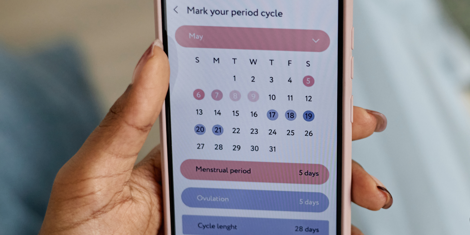 A calendar with a cycle-tracking app or notes on a phone next to it | Alt text: Tracking your cycle 