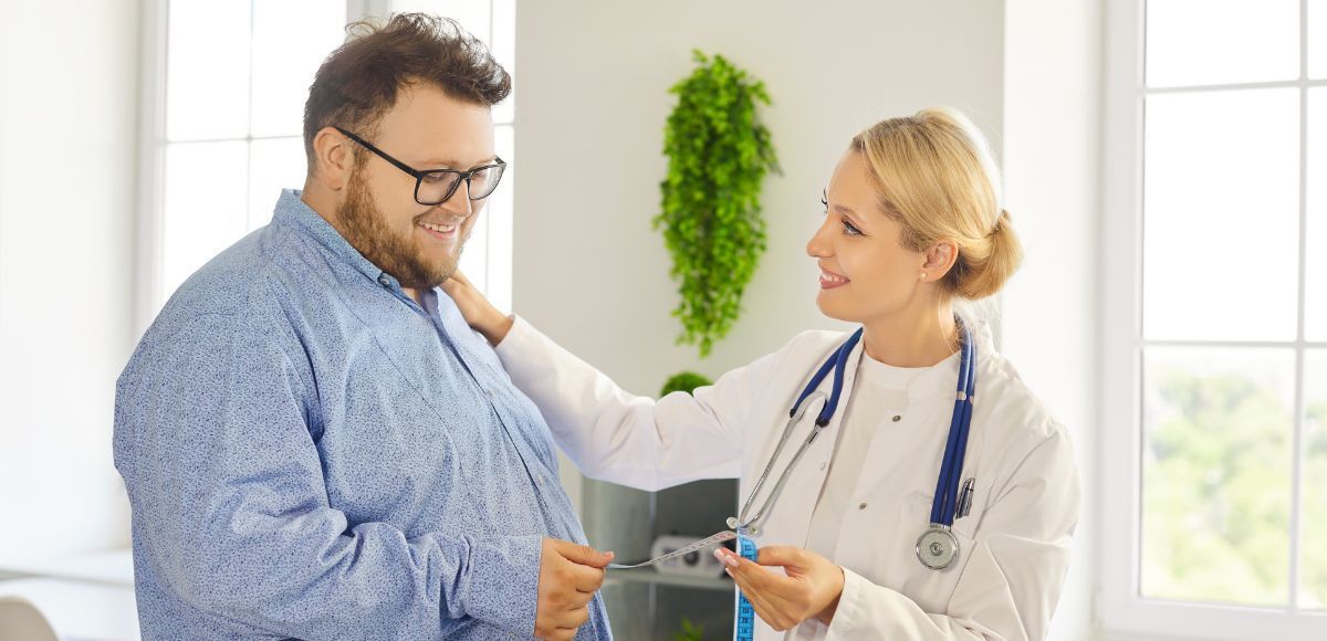 Doctor examining a patient with a stethoscope in a bright clinic