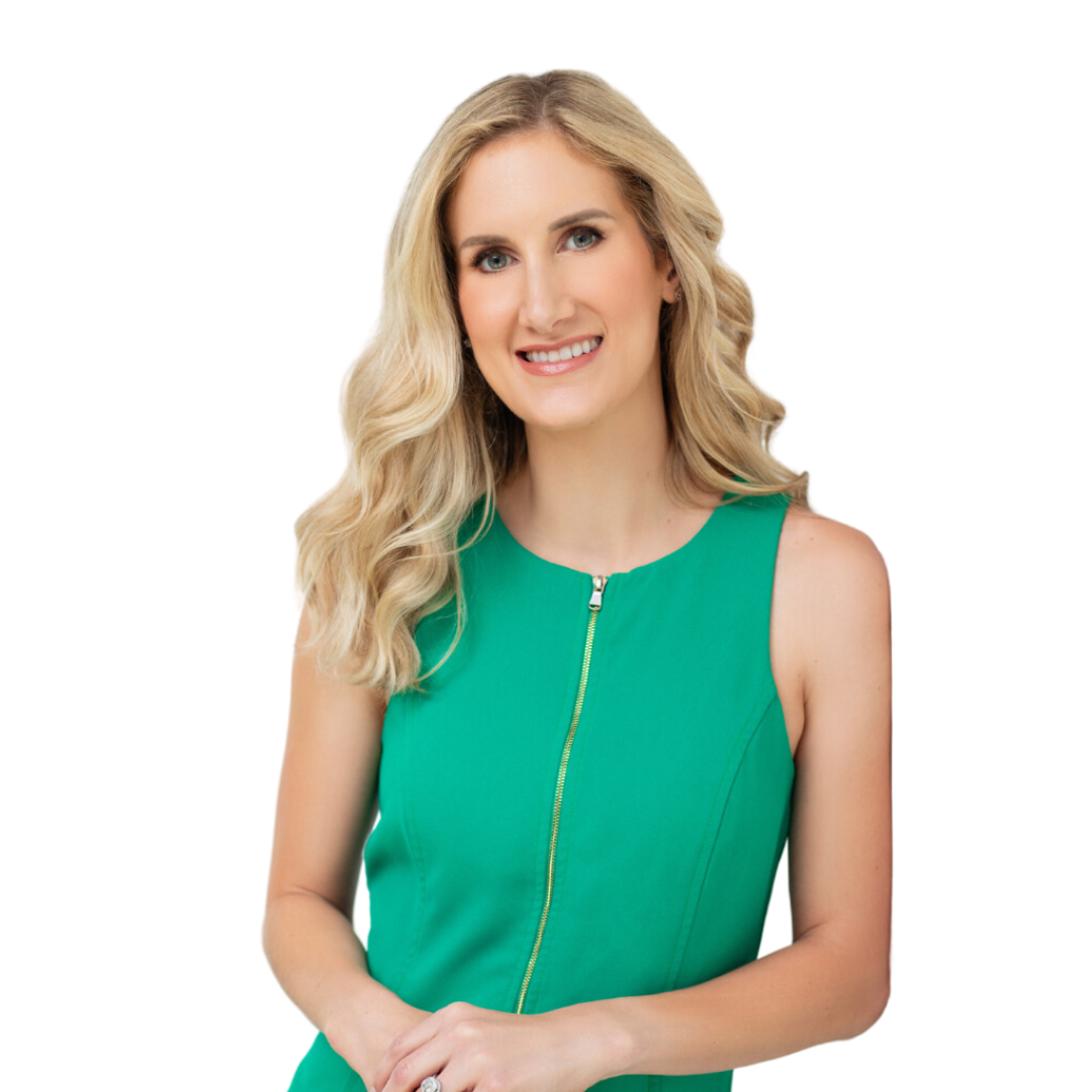 Woman with blonde hair wearing a green dress with a zipper, smiling against a white background.