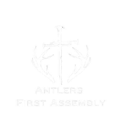 A white logo with a cross and antlers on a white background.