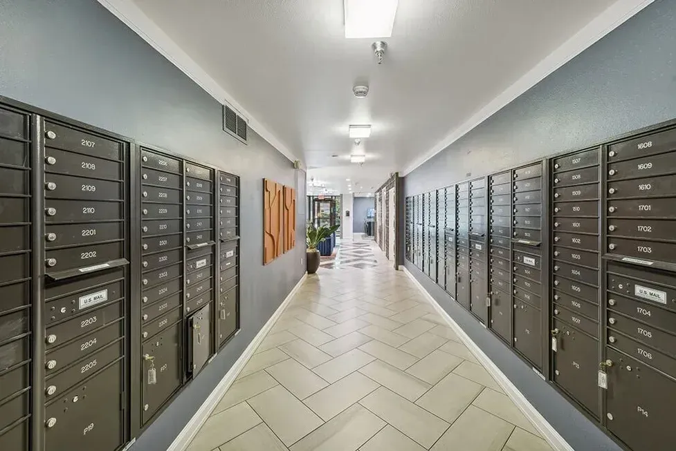 A long hallway filled with mailboxes in a building.