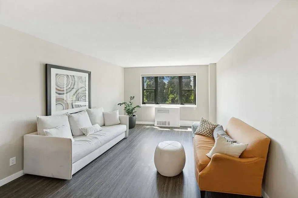 A living room with two couches and a window
