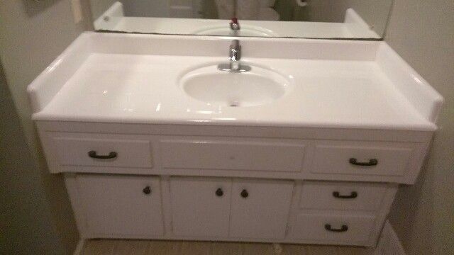 a bathroom vanity with a sink and a mirror