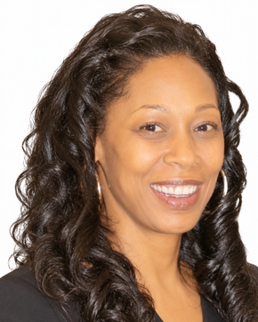 Smiling woman with long dark curly hair against a white background