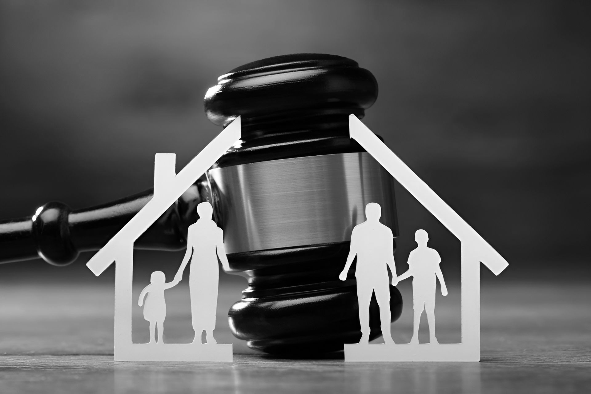 Courtroom gavel behind a white house outline with family silhouettes, symbolizing legal matters in family  - ev law in Bundall, QLDhousing.