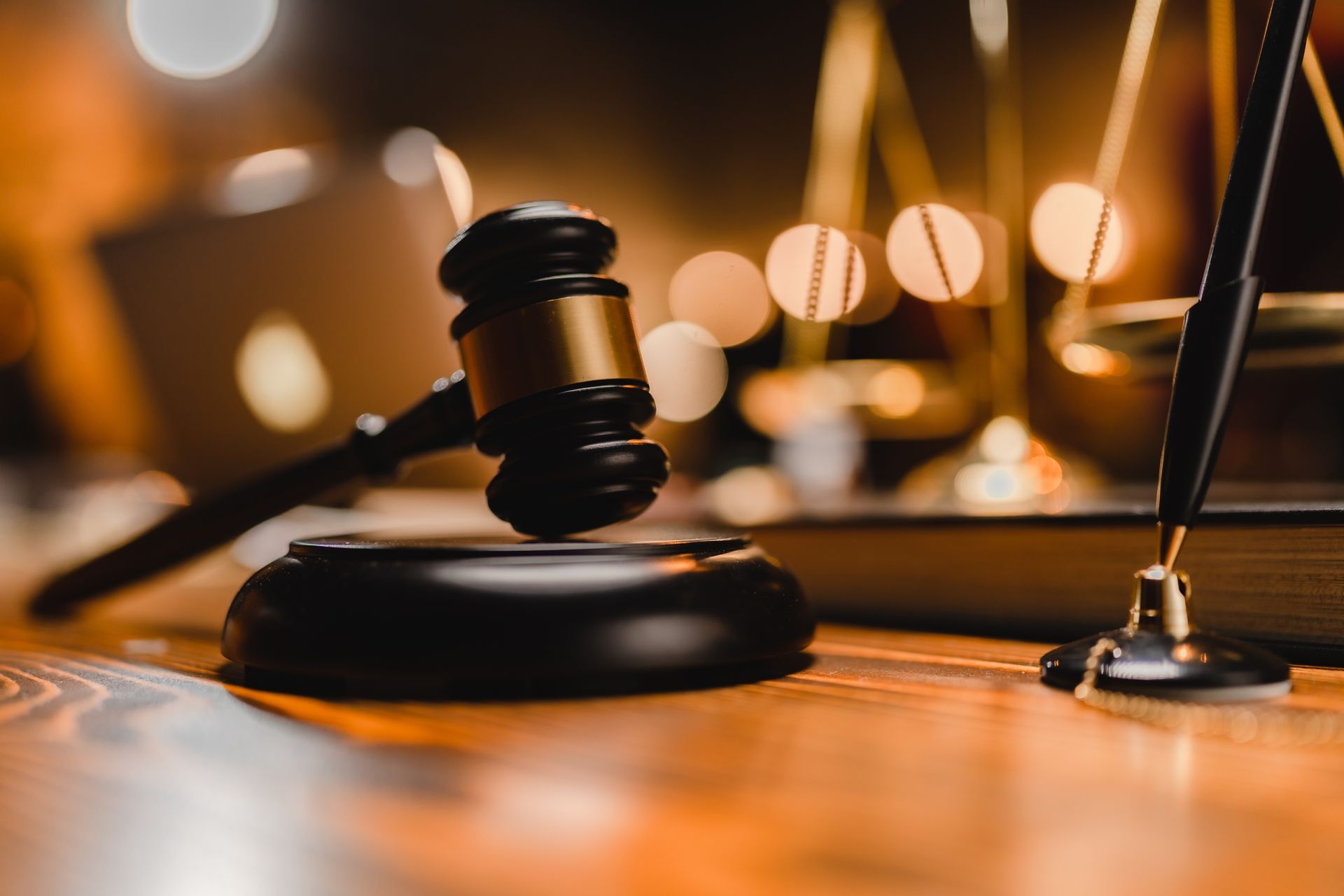 Gavel on a judge’s bench with warm courtroom lights and blurred background - ev law in Bundall, QLD