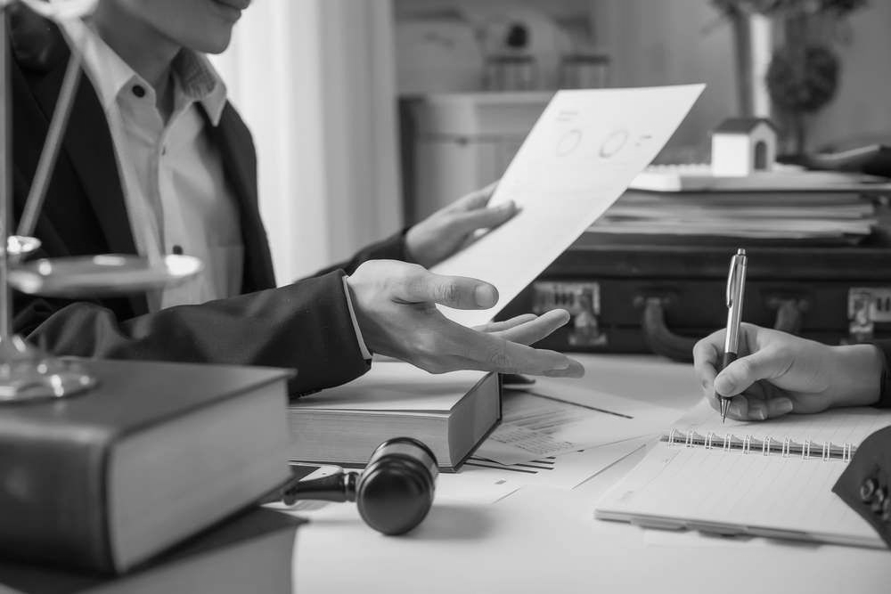 Divorce Lawyer In Robina Reviewing Divorce Paperwork With Client