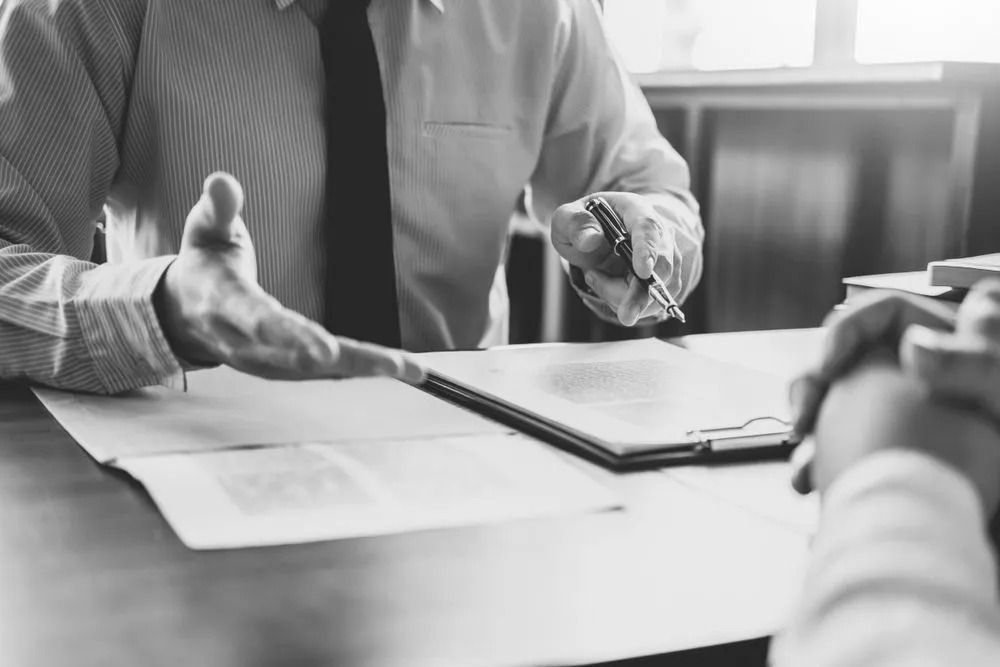 Man Discussing Legal Documents on the Gold Coast