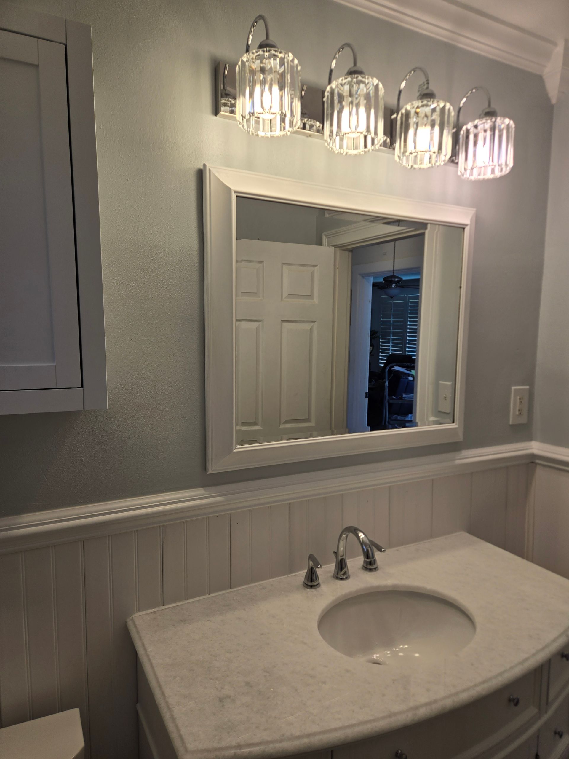 Modern bathroom with white subway tile, black fixtures, and a black vanity.