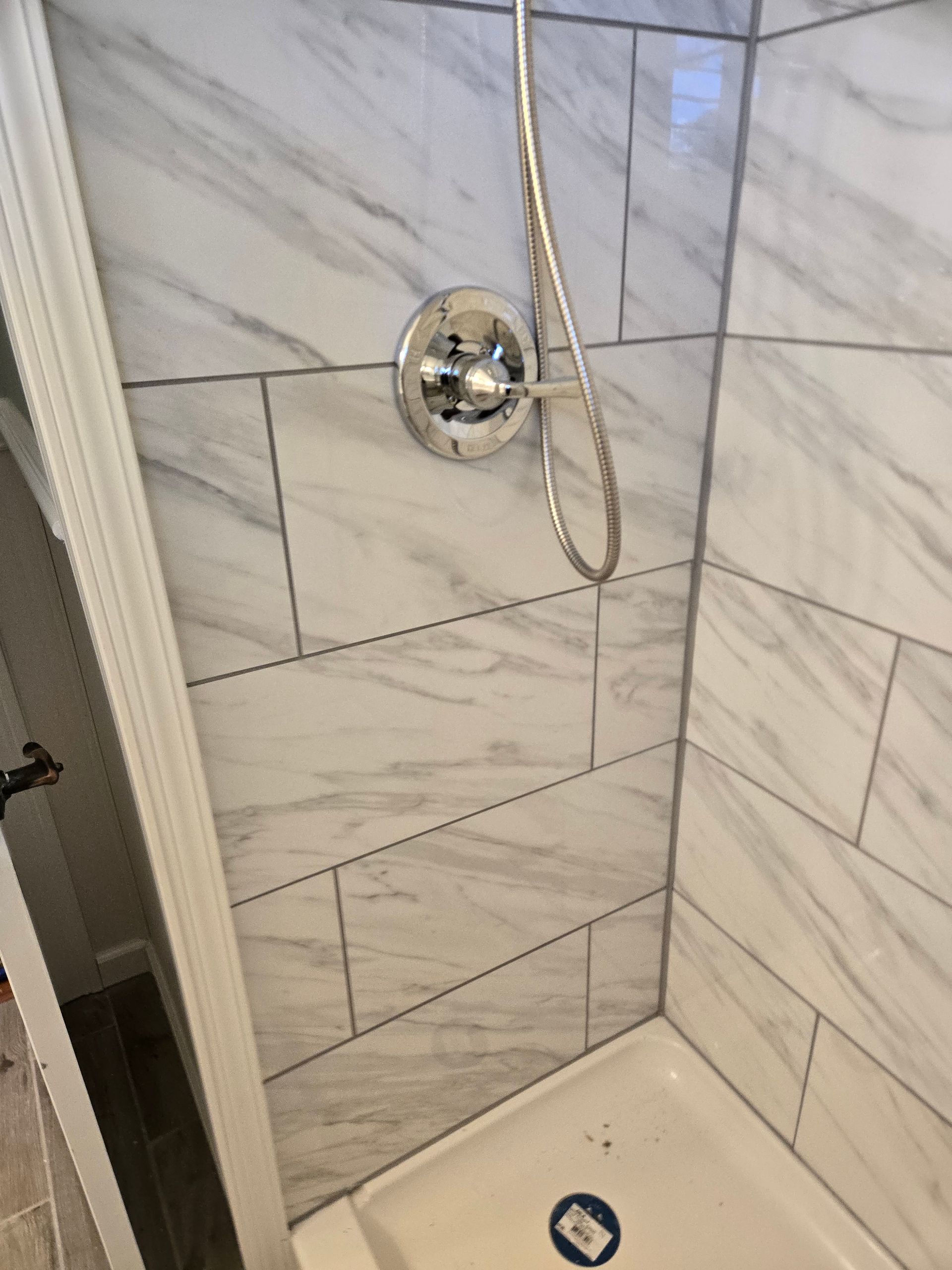 Modern bathroom with marble shower, soaking tub, vanity, skylight, and window.