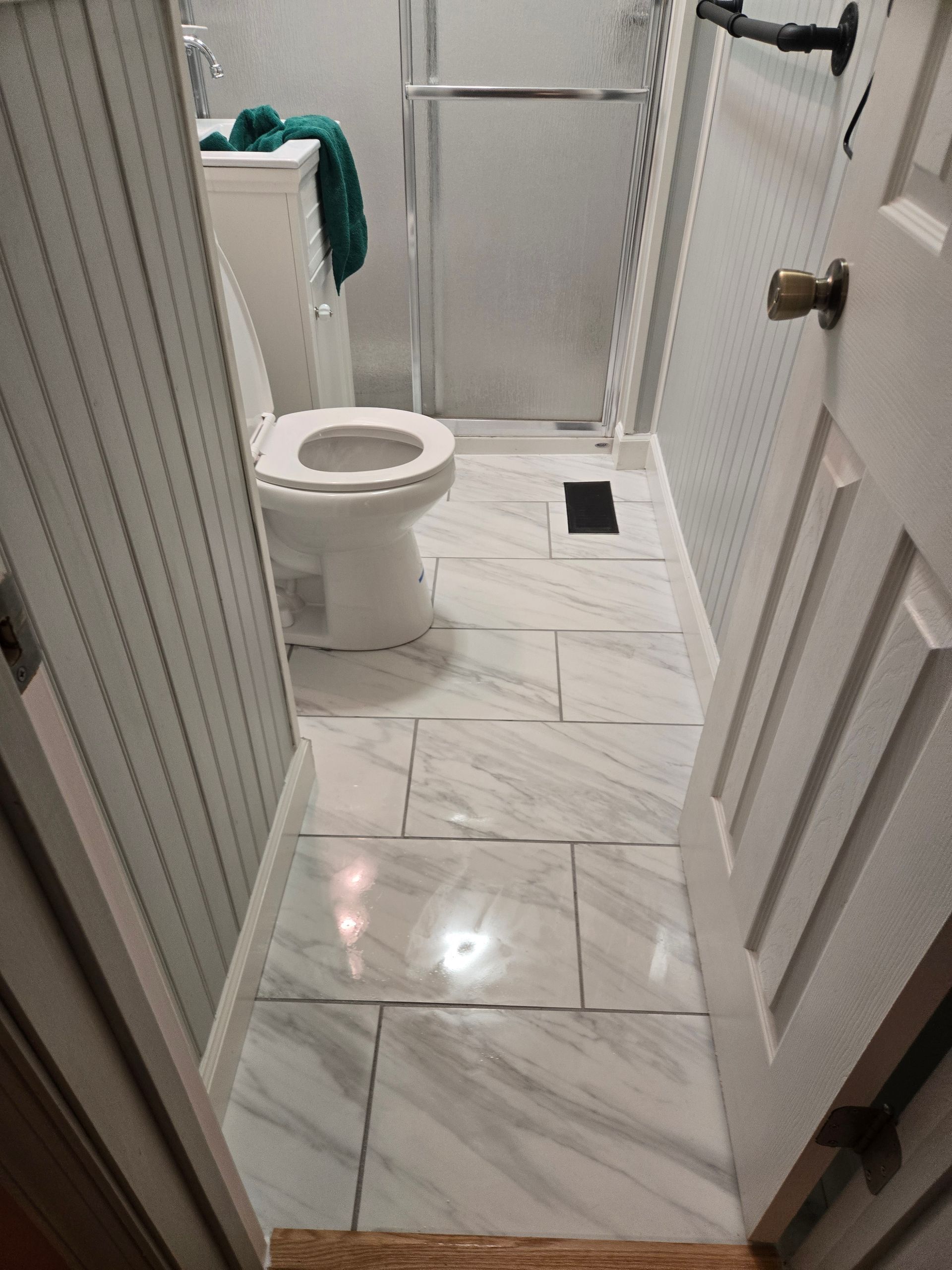 Modern bathroom with a bathtub, shower, double vanity, and large mirror.