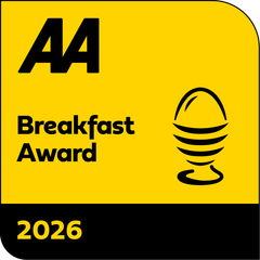 A yellow sign that says aa breakfast award 2025