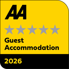 A yellow sign that says aa guest accommodation 2025