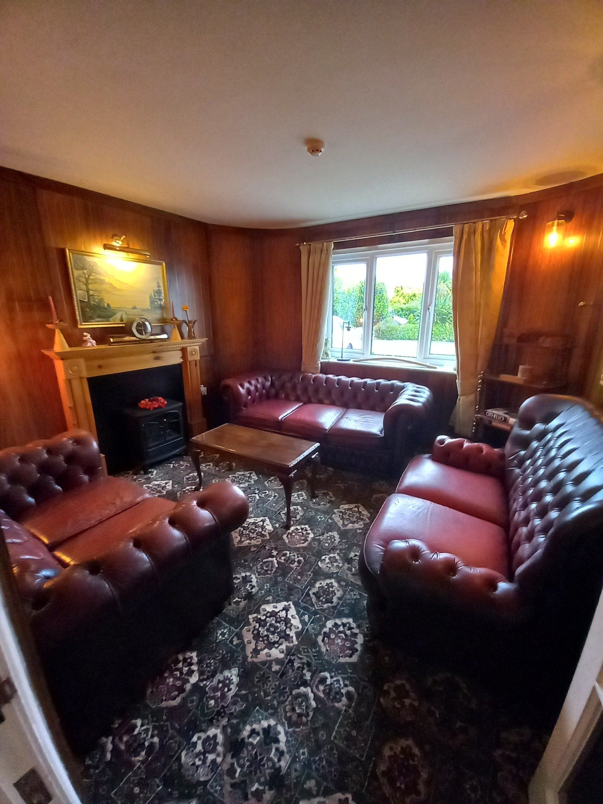 A living room filled with furniture and a fireplace.