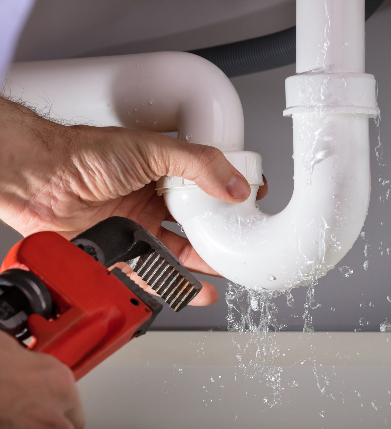 Plumber Fixing Sink Pipe — Lisle, IL – Jim Dhamer Plumbing and Sewer, Inc. Plumber Fixing Sink Pipe — Lisle, IL – Jim Dhamer Plumbing and Sewer, Inc.