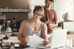 Young Couple Working on Their Utility Bills — Lisle, IL – Jim Dhamer Plumbing and Sewer, Inc. Young Couple Working on Their Utility Bills — Lisle, IL – Jim Dhamer Plumbing and Sewer, Inc.