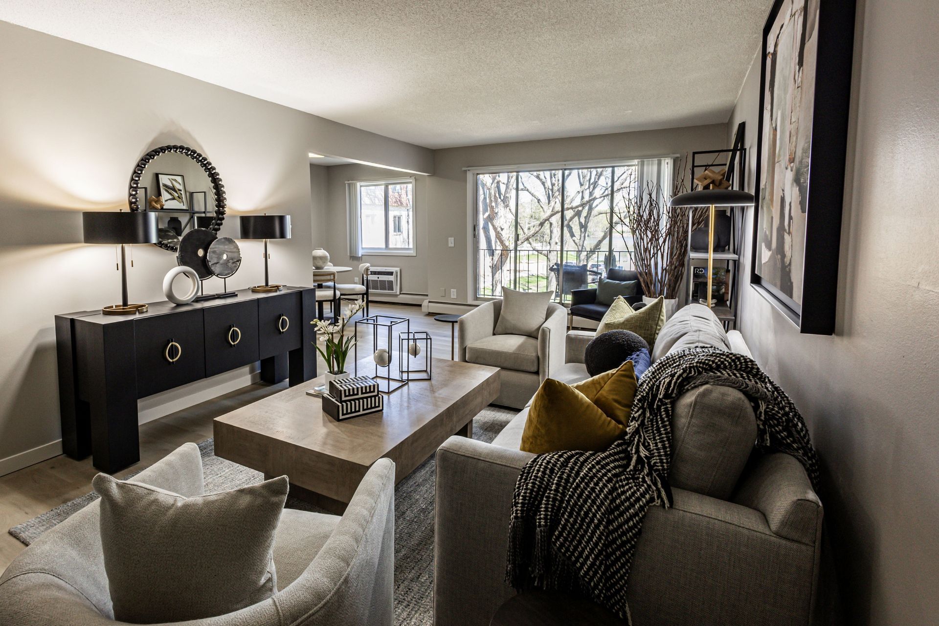 Interior of an apartment living room with a couch and console table - Skyline Real Estate Services