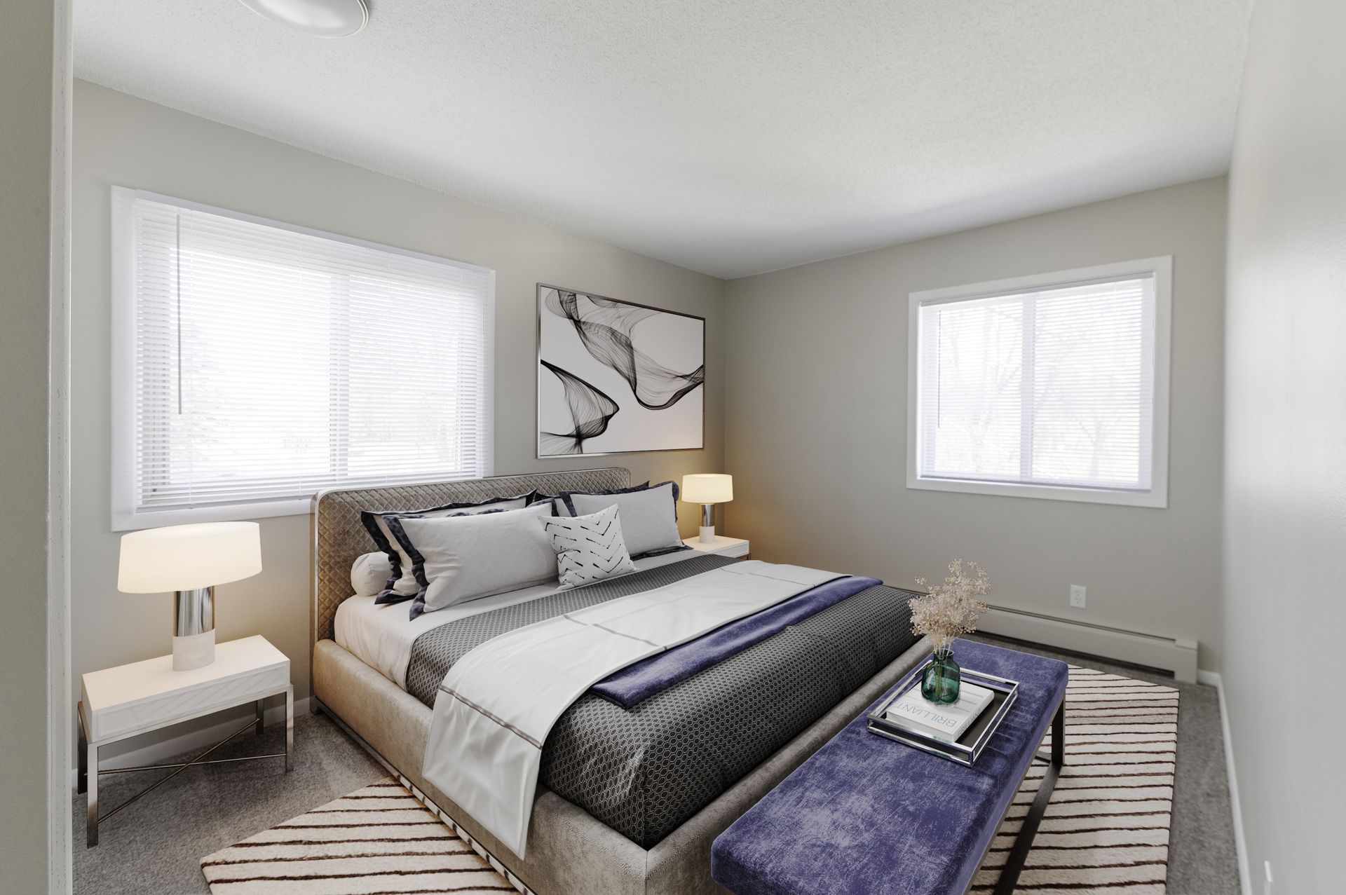 Bright bedroom with a bed, two windows, bedside lamps, and a blue bench at the foot of the bed