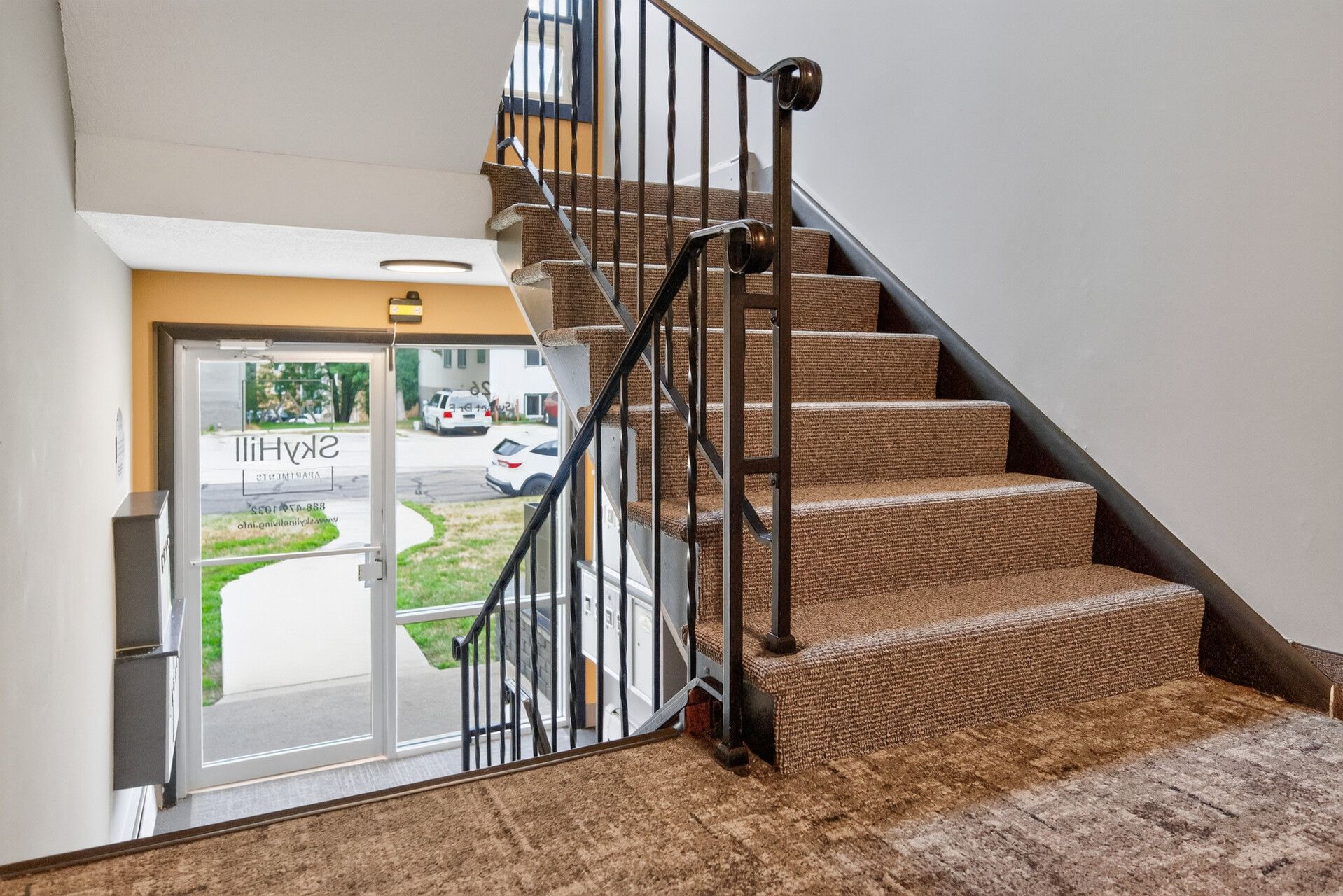 interior of an apartment with stairs and a sliding glass door - Skyline Real Estate Services