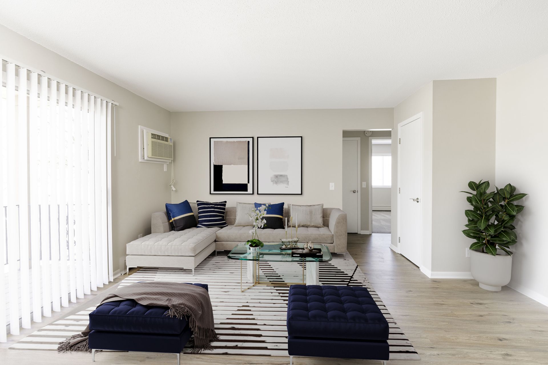 Bright minimalist living room with beige sofa, striped rug, wall art, and potted plant